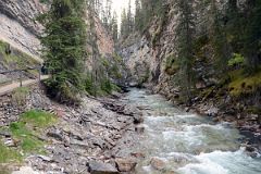 02 Walking Up Boardwalk Next To Johnston Creek Towards Lower Falls In Johnston Canyon In Summer.jpg